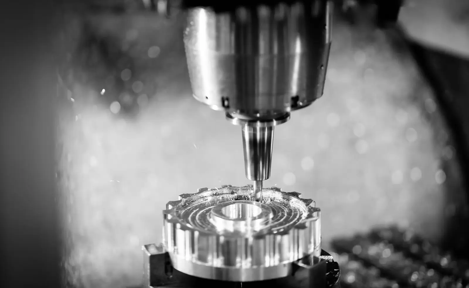 A CNC milling tool cuts a round metal part